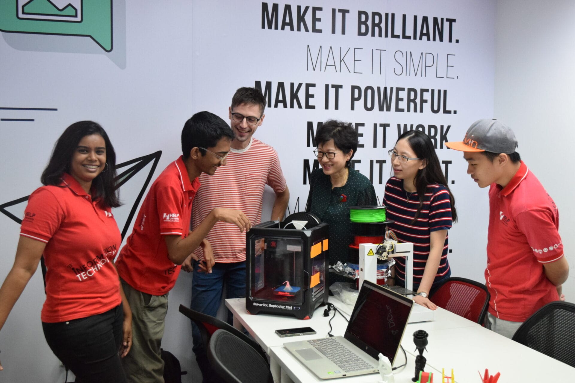 Dr Sien Ven Yu with information technology students looking at a 3D printed Eiffel Tower